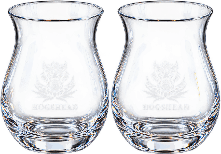 Two Tusk'ave tasting glasses, empty, each etched with the boar emblem over the word Hogshead, showing the wide bowl, tapered mouth and solid base